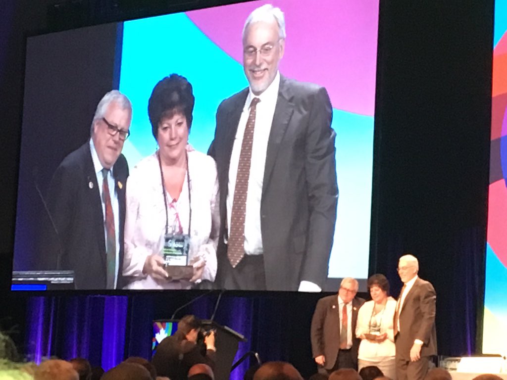 Past President Button receiving FCM Roll of Honor award 